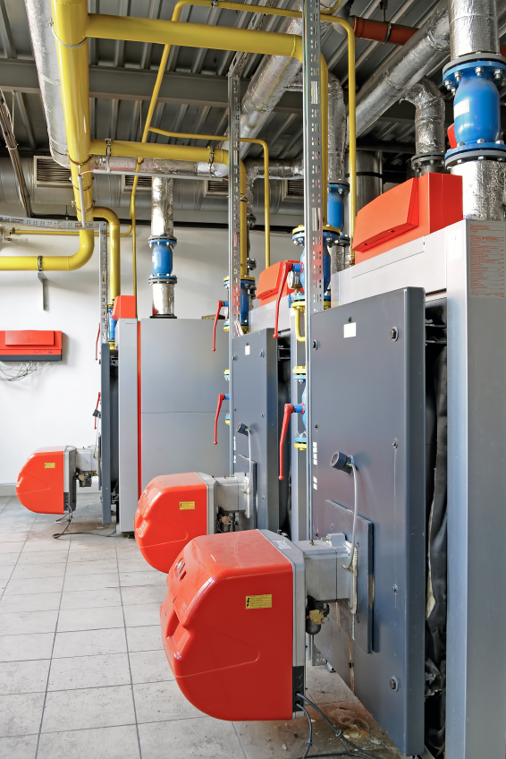 Commercial gas boiler plant room with yellow gas pipework