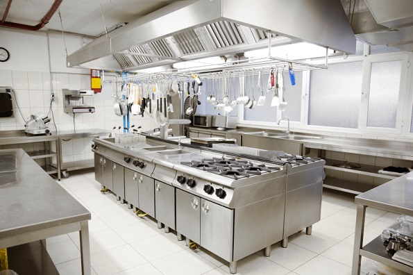 Commercial kitchen with cooking suite under extraction canopy