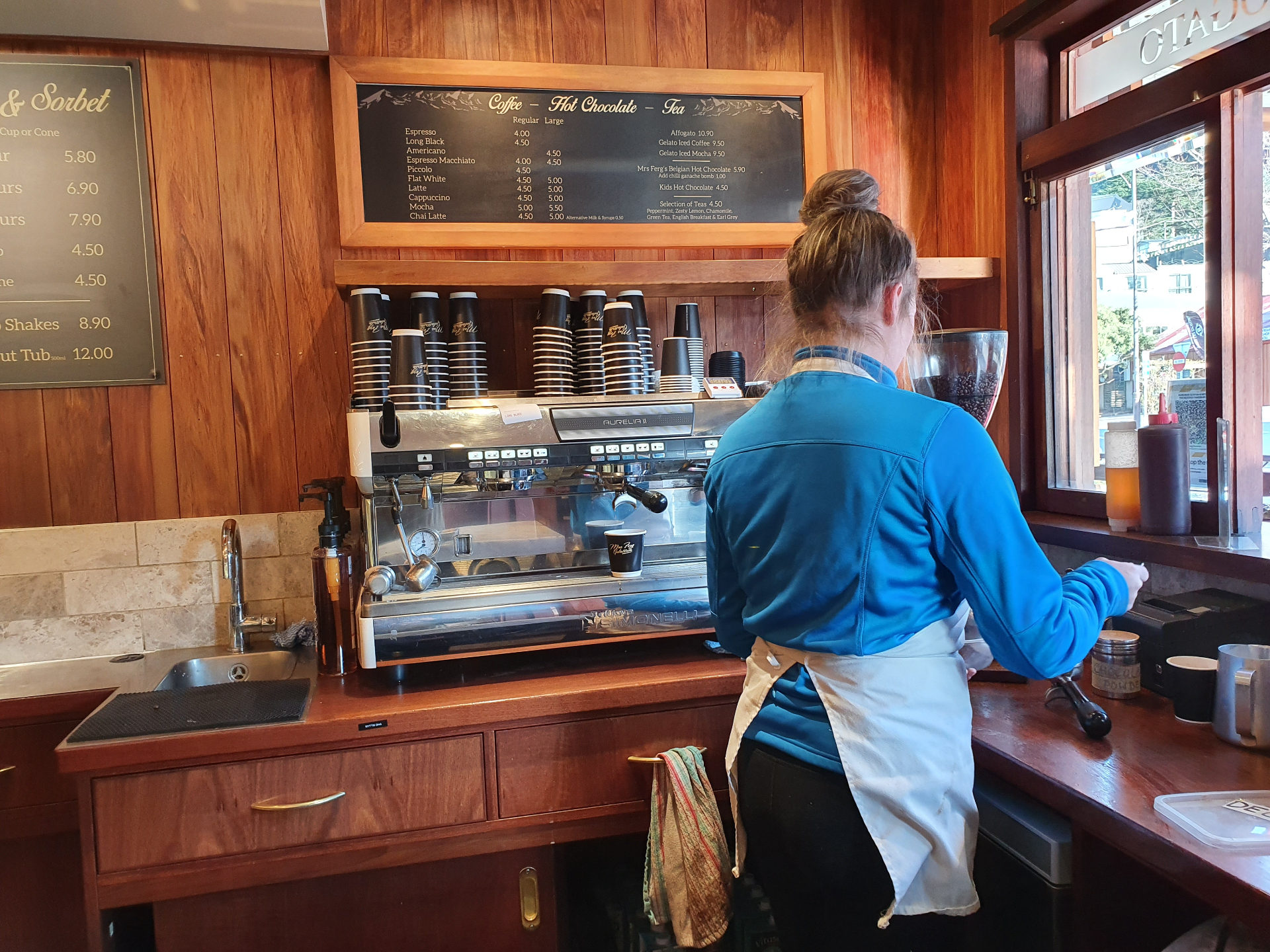 Barista at commercial espresso machine on LPG hot water supply