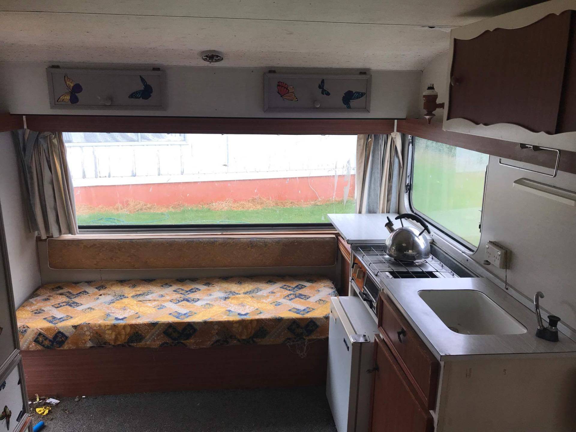 Vintage caravan interior with original gas cooker for upgrade