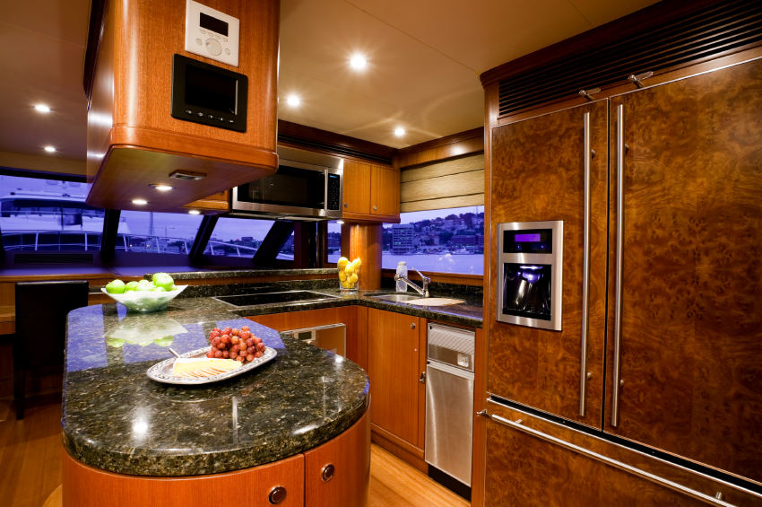 Luxury launch galley with gas cooktop and marine finishes